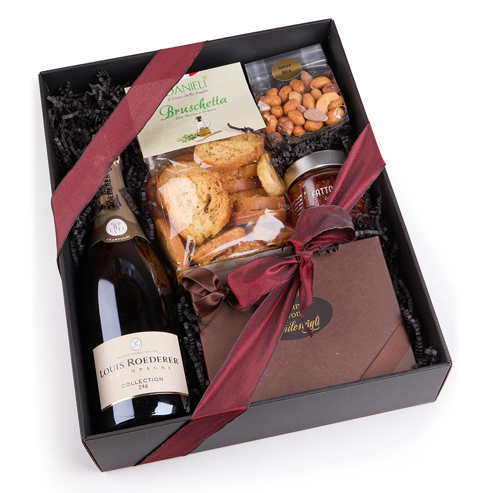 Luxus Geschenkbox mit Champagner, Pralinen und feinen Snacks stilvoll arrangiert