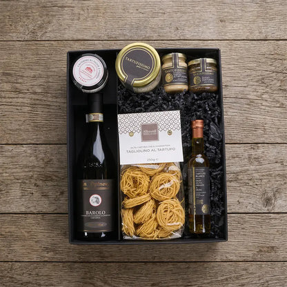 Geschenkbox mit Barolo Wein und Trüffel-Delikatessen wie Trüffelpasta und Spezialitäten, stilvoll verpackt